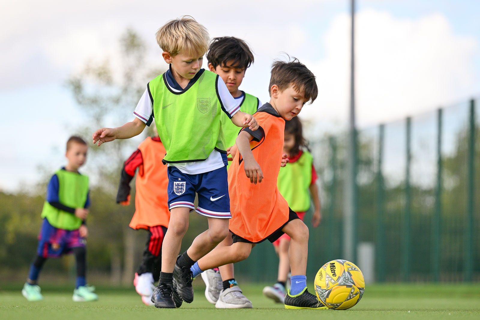 Children dribbling between cones in an FC Alpha academy session
