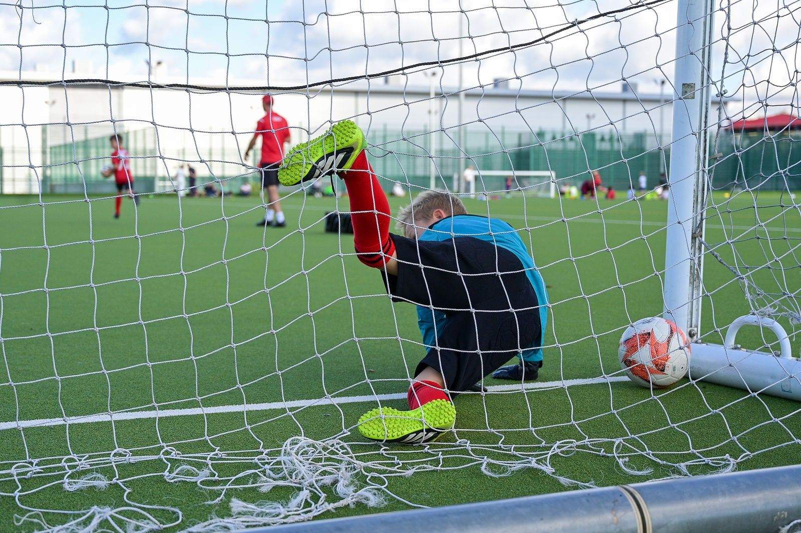 A young goalkeeper diving to save in training