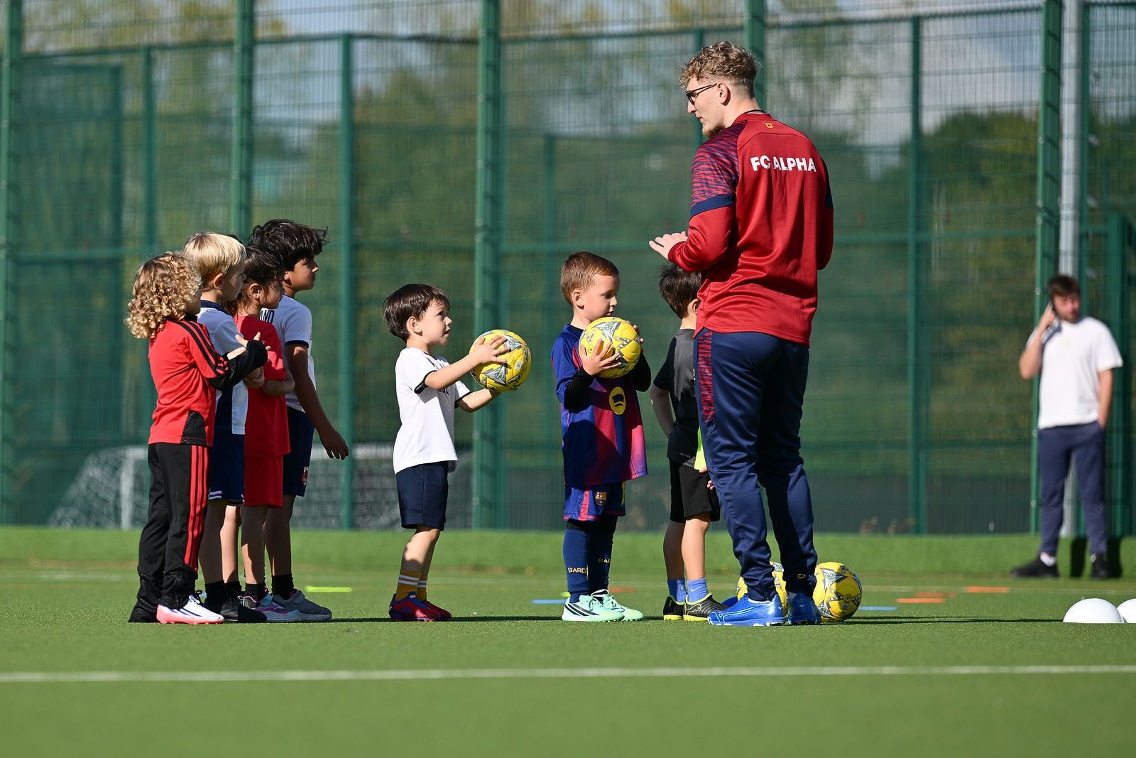 A coach working with a small group of the youngest players