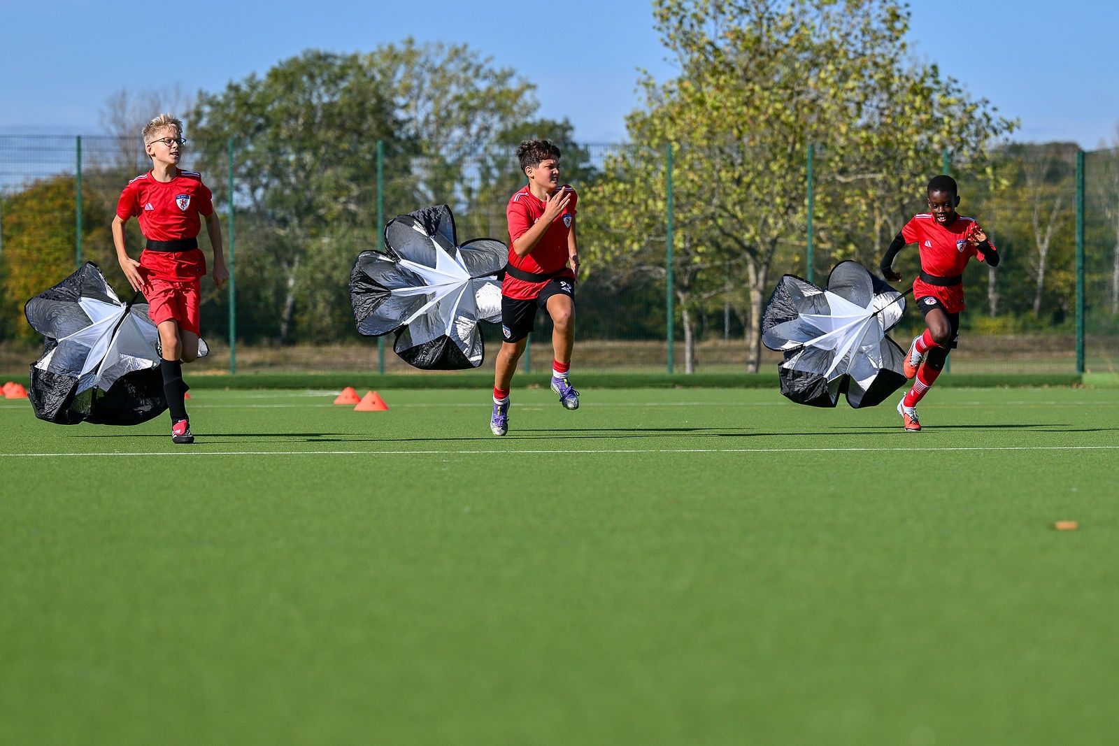 A coach setting up a drill with a group of young players