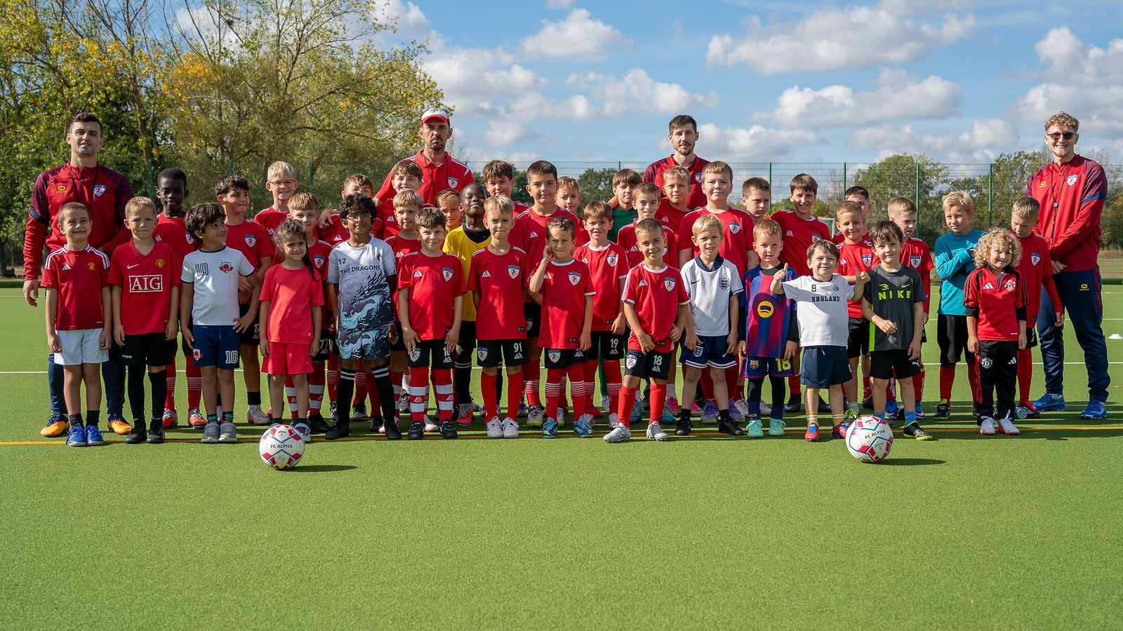 The whole FC Alpha academy with its coaches on the pitch at Basildon Sporting Village