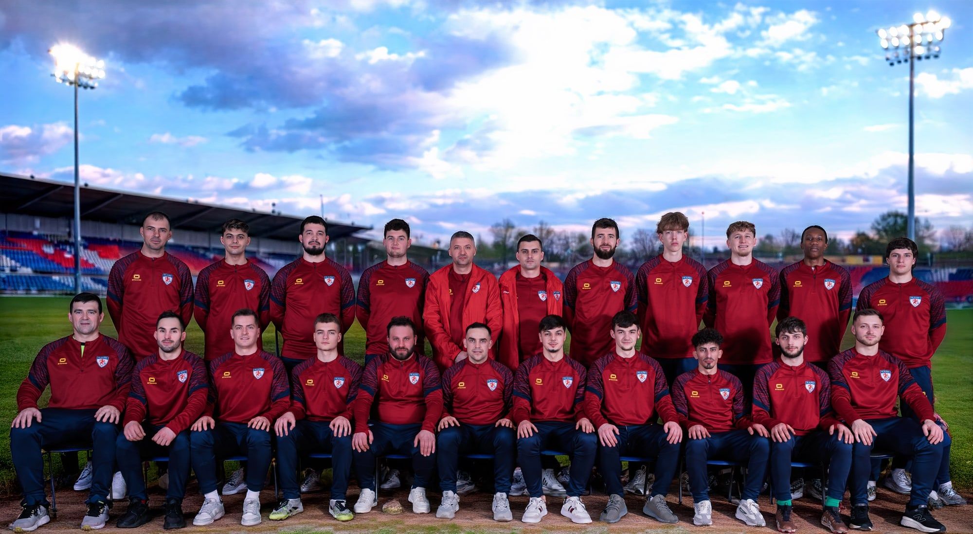 FC Alpha senior squad photo in red club jackets